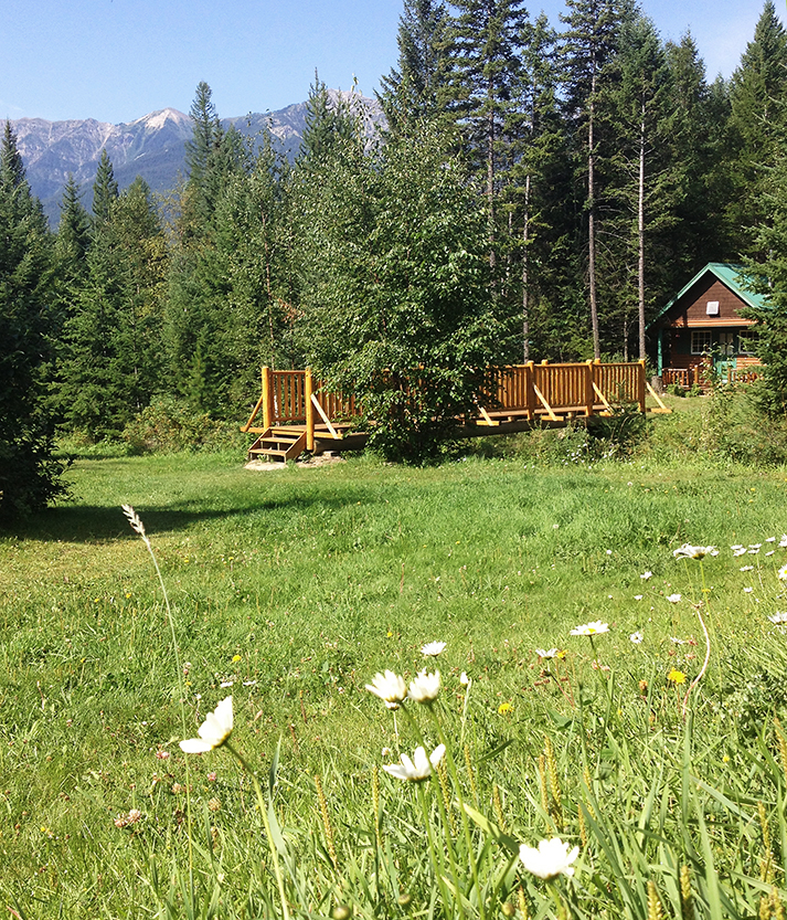 The main lodge grounds looking across the bridge to the heritage cabins at Cross River