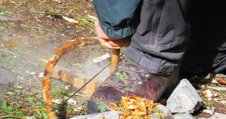 Making a fire by friction during an ancestral skills week outdoor education program in the Yearling peaks at Cross River